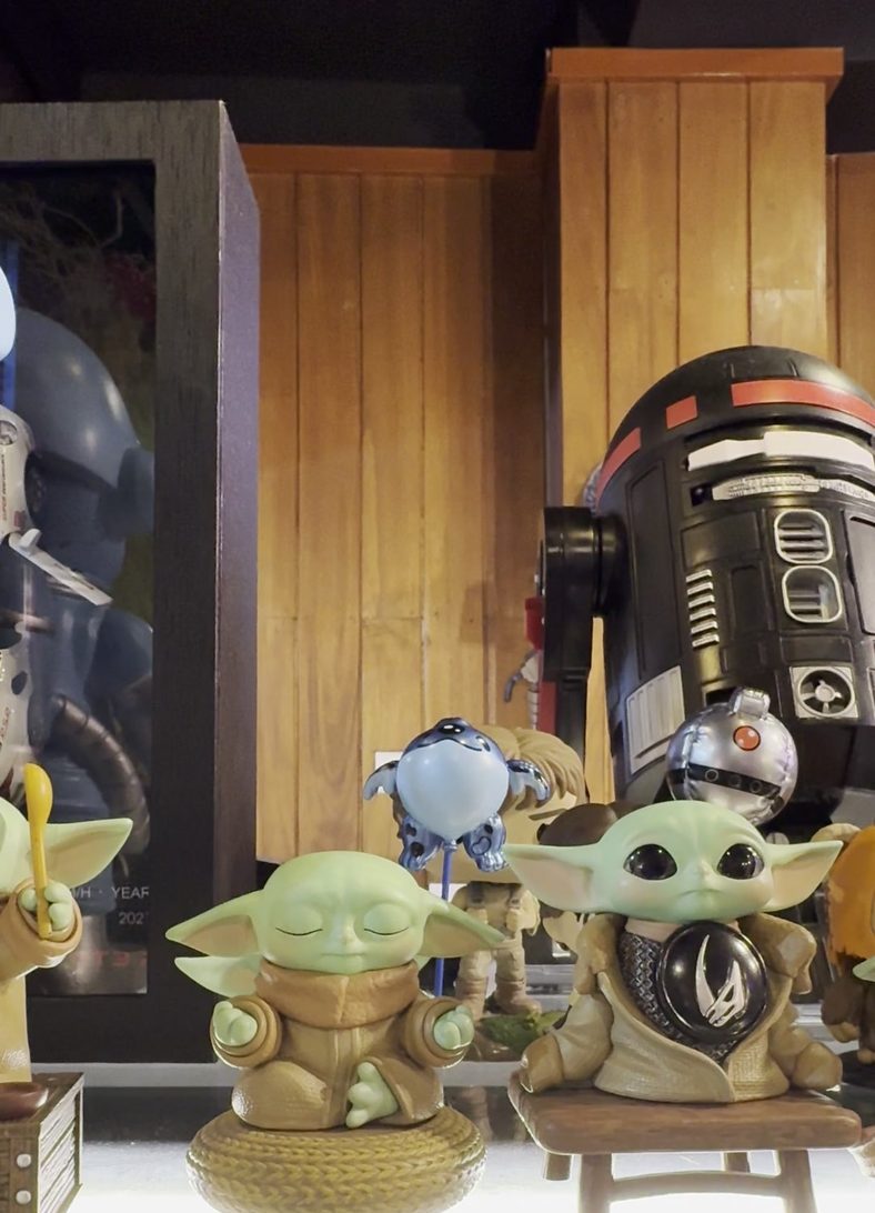 A lit shelf of collectible figures
