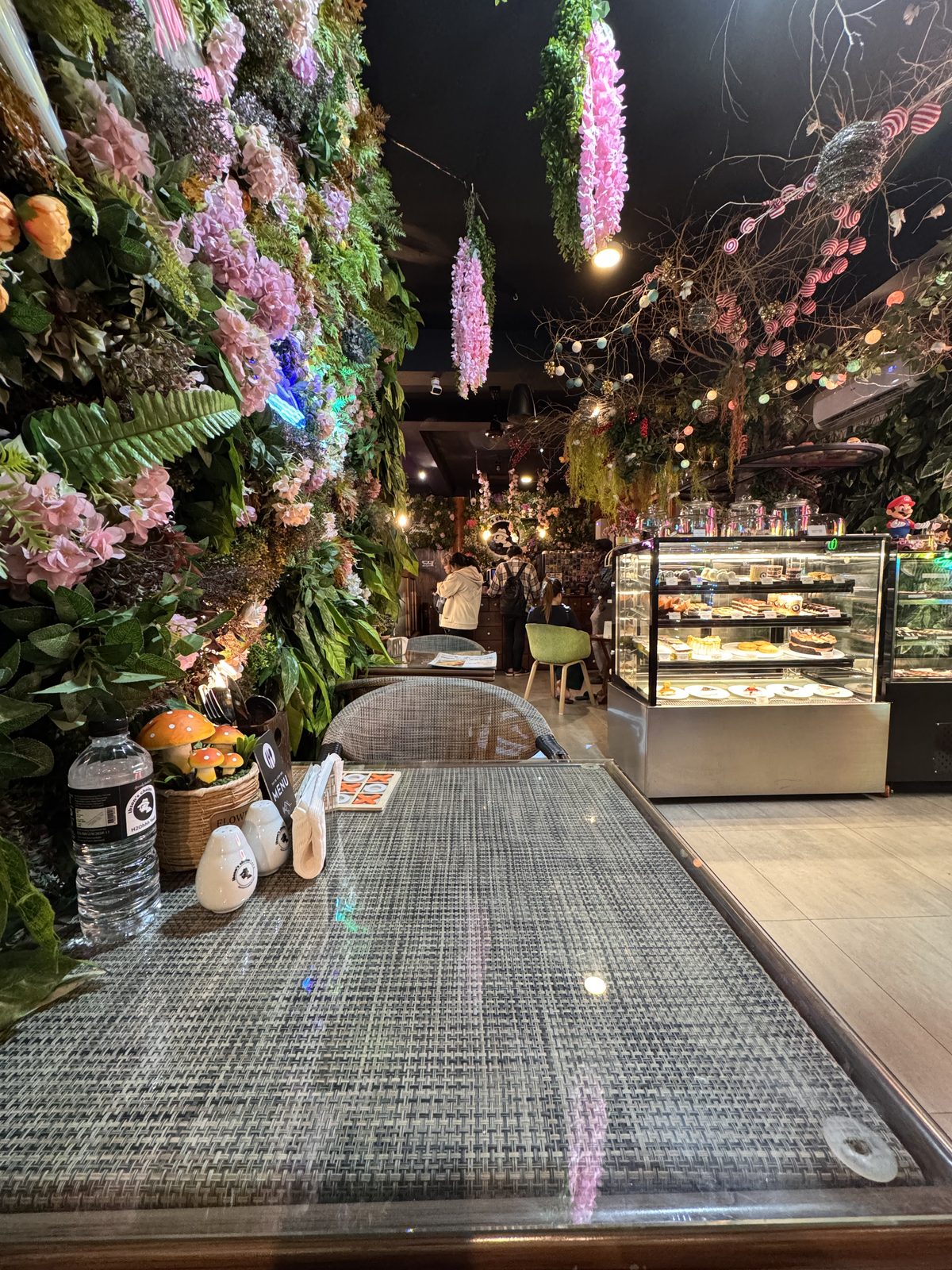 A flower wall beside the pastry case