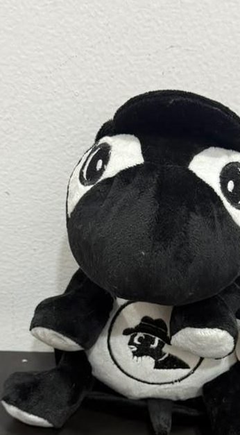 The Ibson plush, hat on, badge out